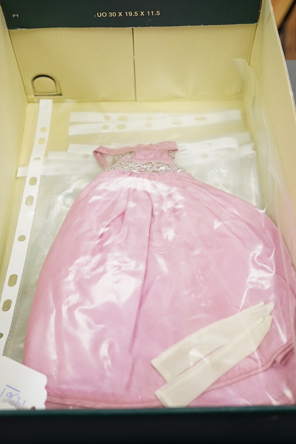 A 1960's Mattel Inc. Barbie doll, 1963, together with a Skipper doll, and a collection of eight original outfits with accessories, sorted into individual packets, outfits purchased between 1963 to 1966 include; American